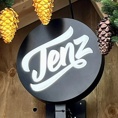 Round double sided lightbox sign waterproof for outdoor use on a wooden background