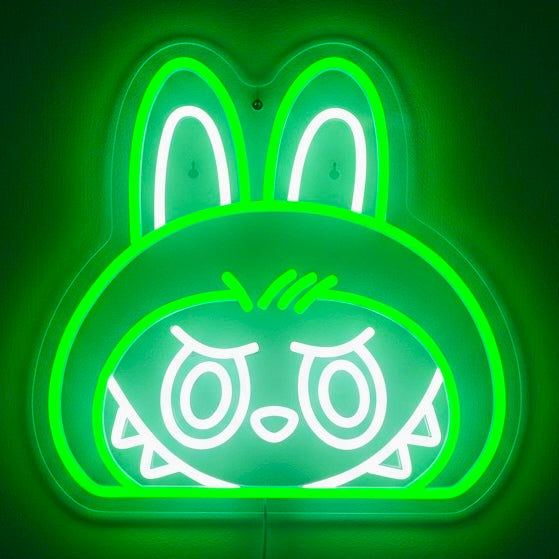 Neon green rabbit-shaped sign with white outline on a dark green background