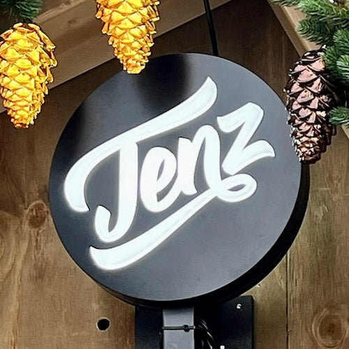 Round double sided lightbox sign waterproof for outdoor use on a wooden background