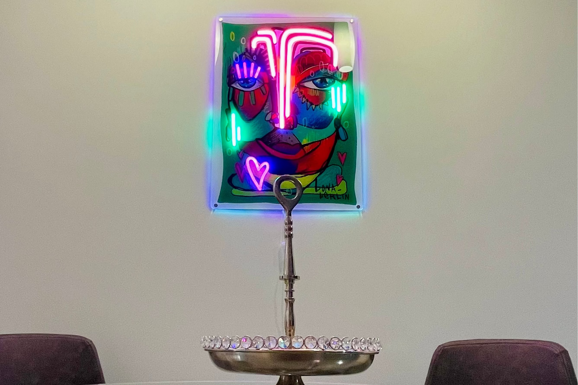 Neon art sign on a wall above a glass dining table home decor